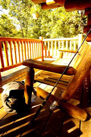 Hastings patio with log chairs and fishing rod