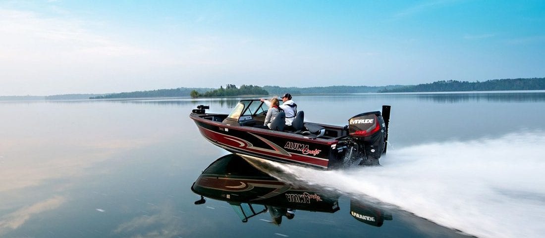 An old guy with a dog sitting in a motorboat